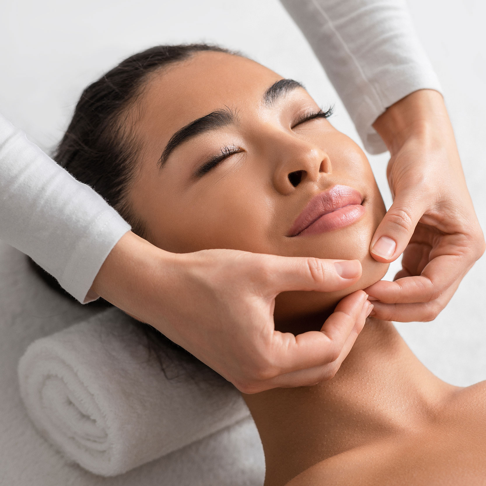 acupuncture facial rejuvenation, image of a woman getting acupuncture facial rejuvenation and smiling.