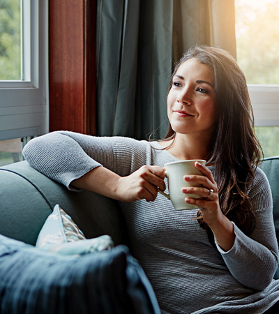 mobile-acupuncture-near me, image of woman at home waiting for her appointment, drinking tea.